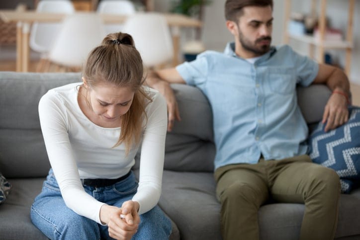 Unhappy married couple at home.
