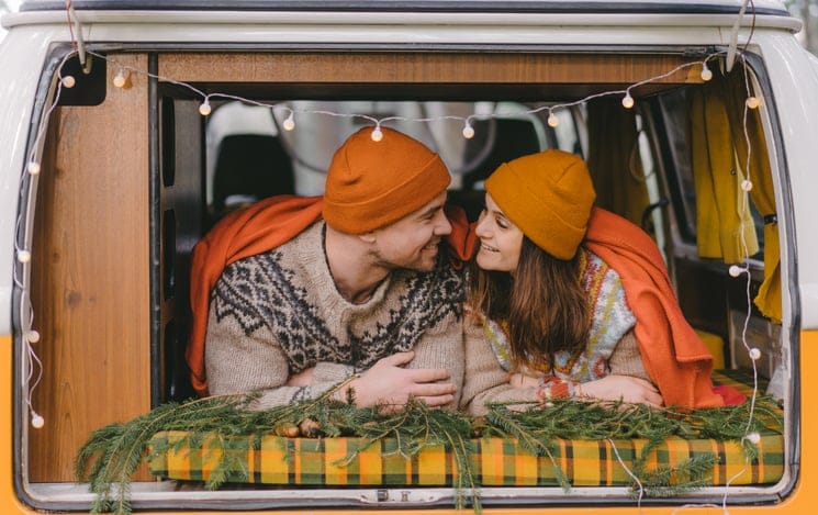couple kissing in a camper van