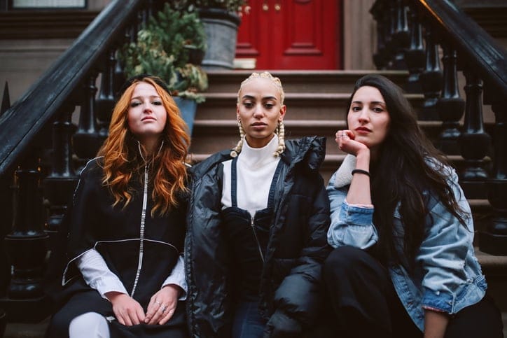 three multi-cultural ladies facing camera