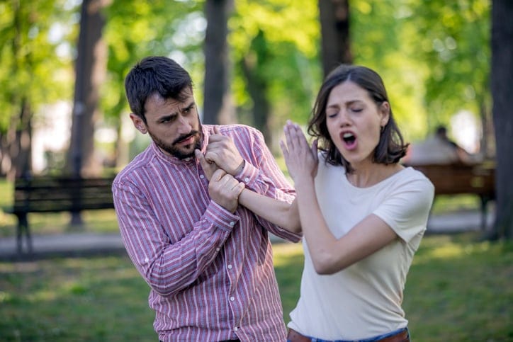 young couple arguing in the park