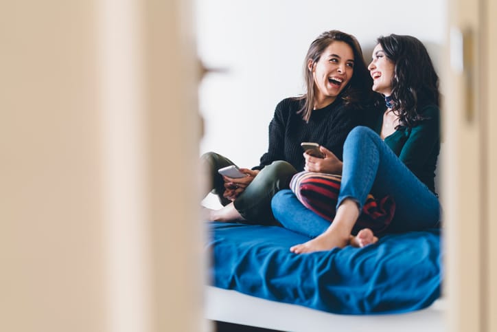 two friends laughing at home