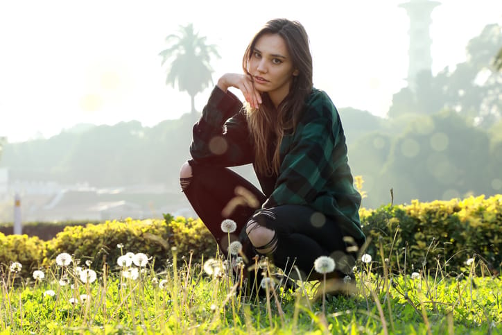 young woman sitting in the grass