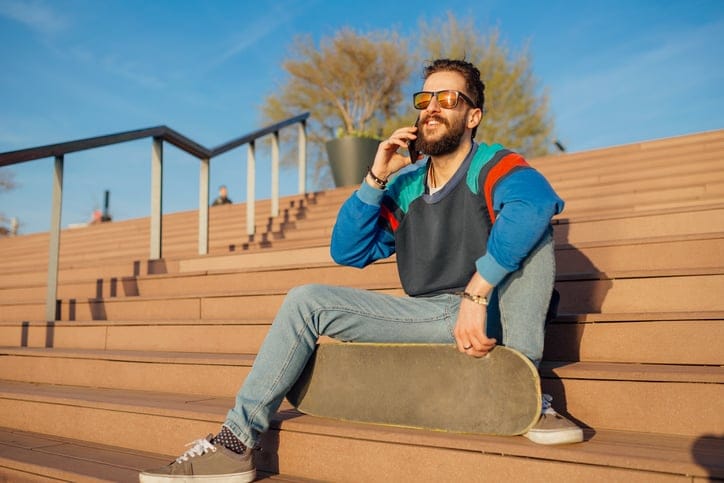guy sitting on steps talking on smartphone