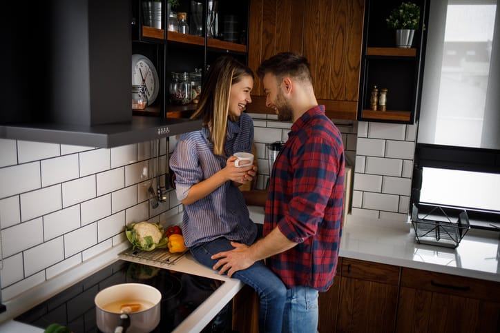 couple kissing in the kitchen