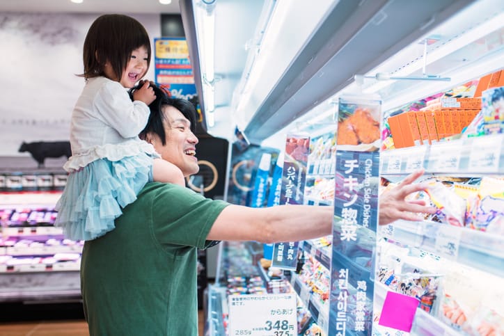 Father and child grocery shopping.