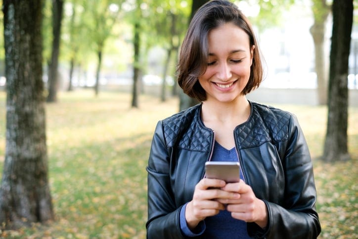 woman in the park looking at mobile