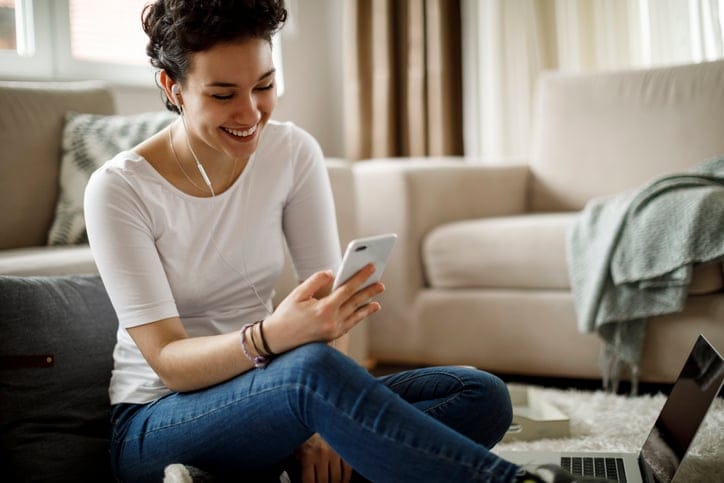 woman sitting at home texting