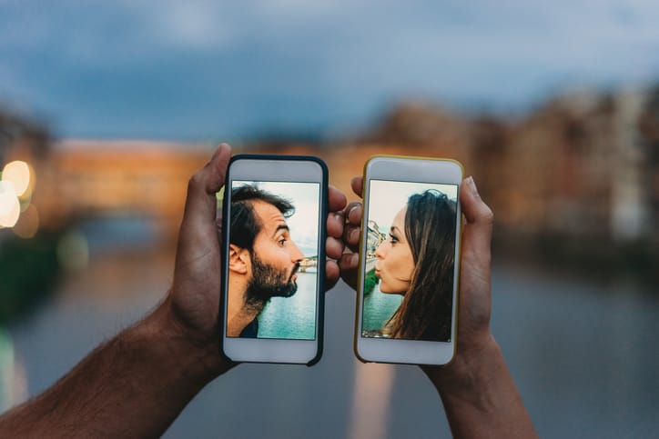 two hands holding two mobile phones