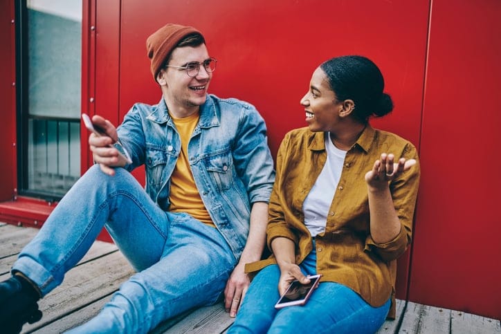 biracial couple sitting outside