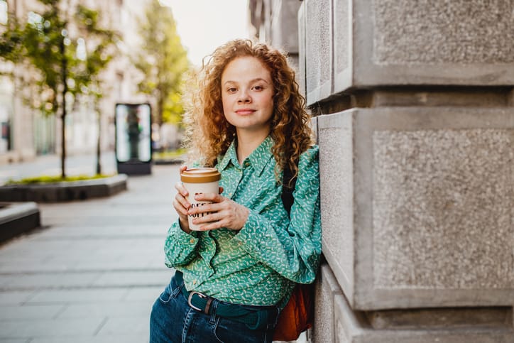 curly ginger haired woman with coffee