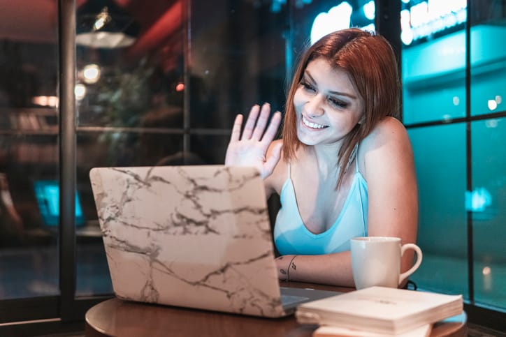 woman waving to someone online