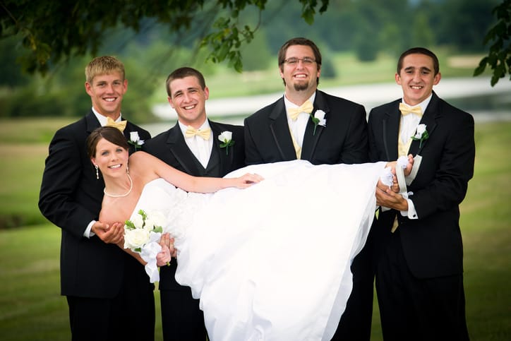 Woman with groomsmen at her wedding.
