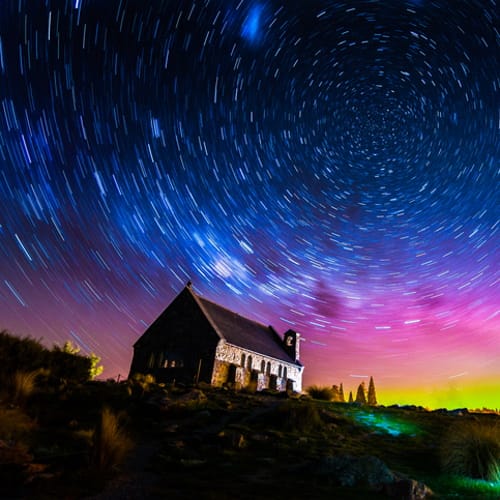 Starry night over a house.