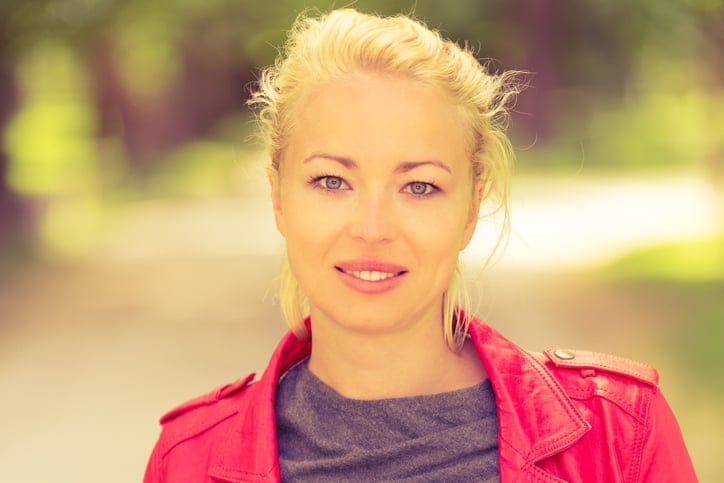 young blonde woman smiling at the camera