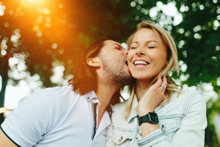 Young husband and wife outside.