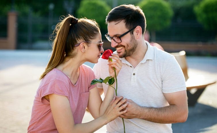 man giving woman a rose