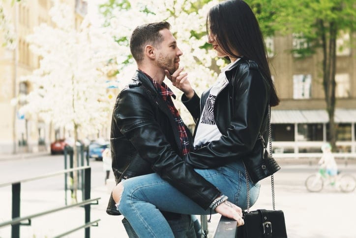 couple in leather jackets being intimate