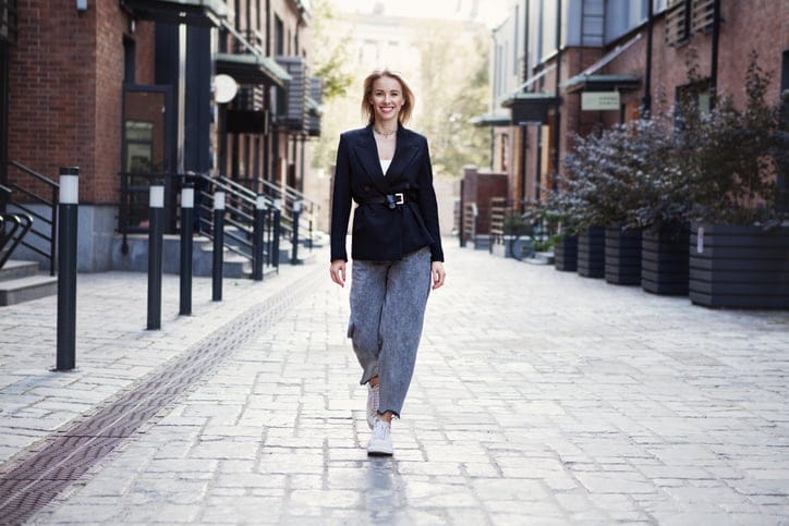 blonde woman walking proudly in the street