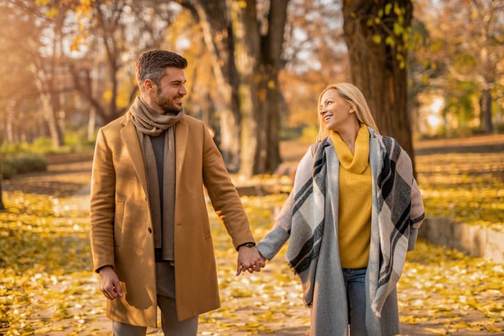 Happy couple holding hands in the park