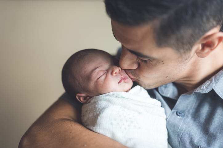 dad kissing a baby