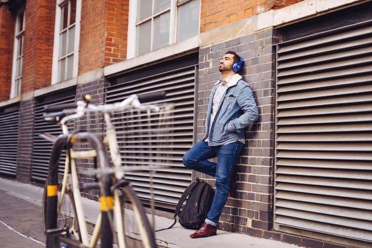 man leaning up against a wall