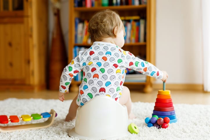 toddler sitting on a potty