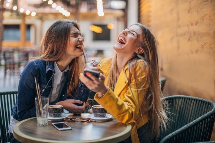 two friends laughing at the coffee table