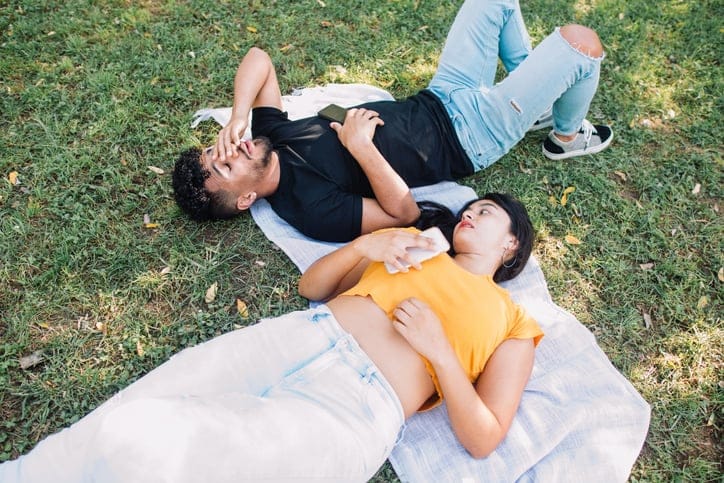 unhappy couple having argument in park