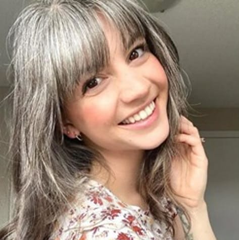 Woman with grey hair and bangs.
