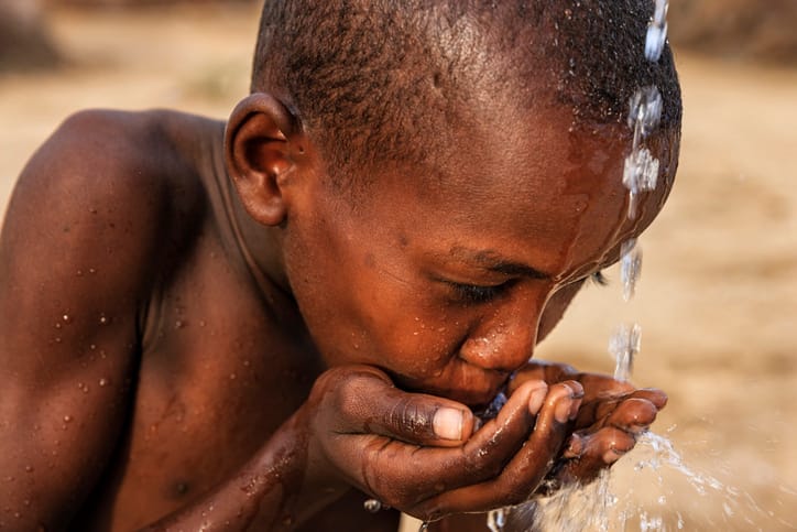 black child drinking water
