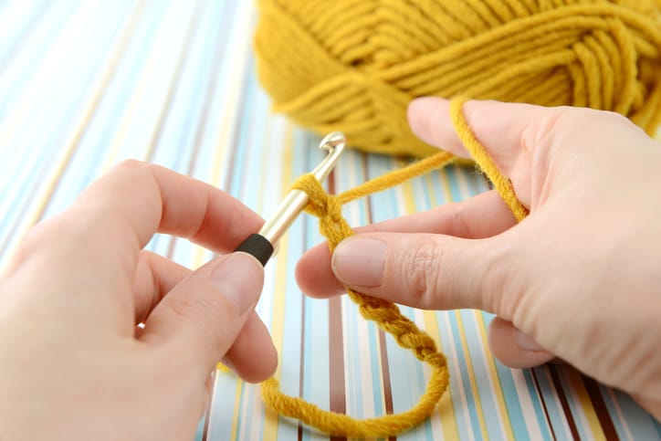 A woman crocheting.