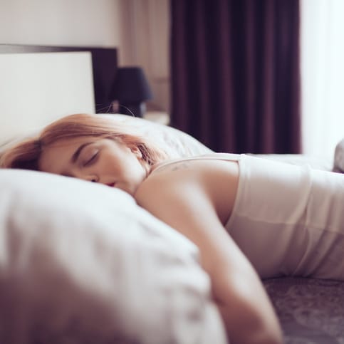 Woman laying in bed.