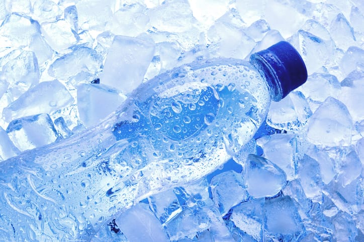 Bottled water with ice cubes.