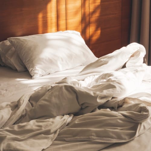 A bed with bedsheets.