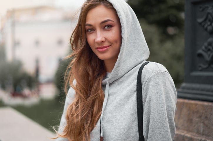 woman dressed in a grey hoodie