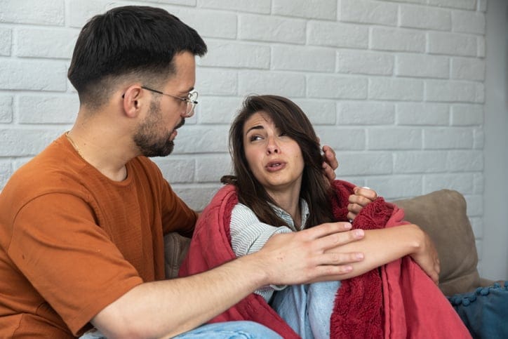 couple sitting on the couch talking