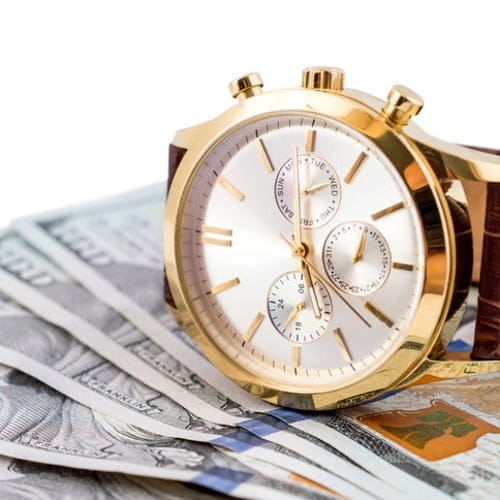 Wrist watch on money.