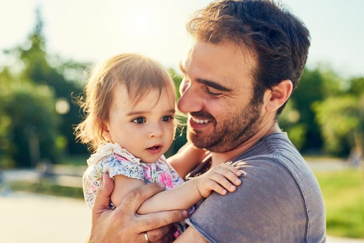 man with child in his arms