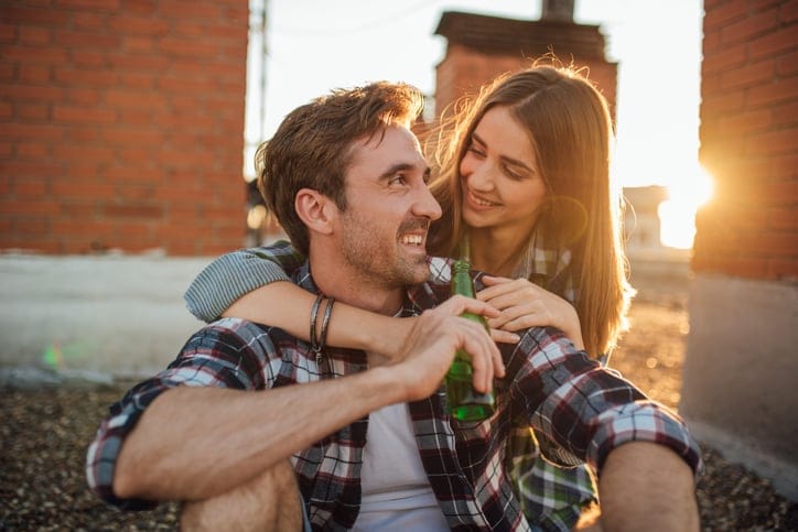 young couple outside sunset