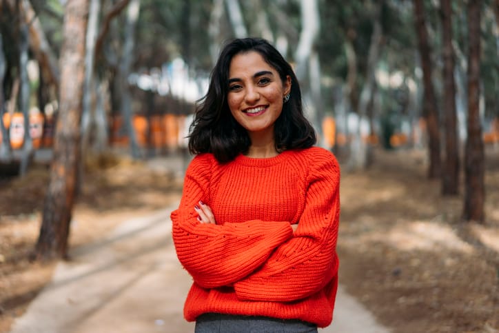 smiling woman in red sweater