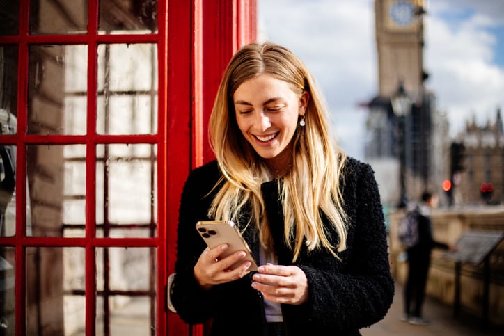 smiling woman looking at phone