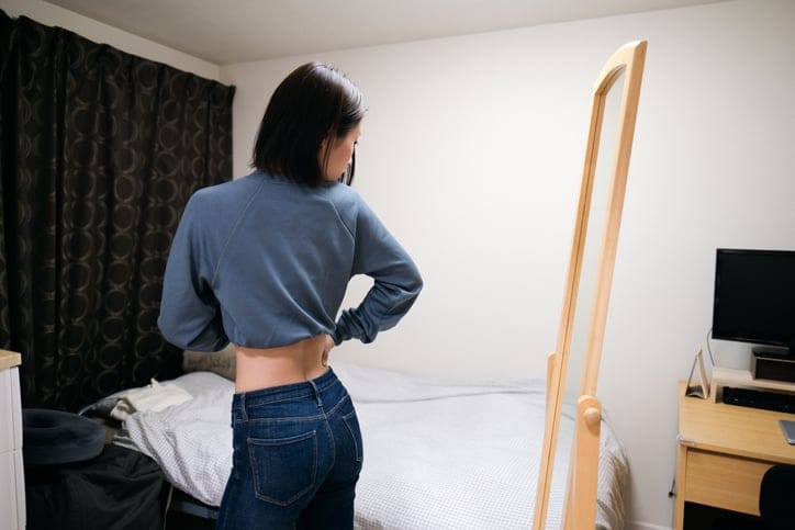 woman looking in the mirror