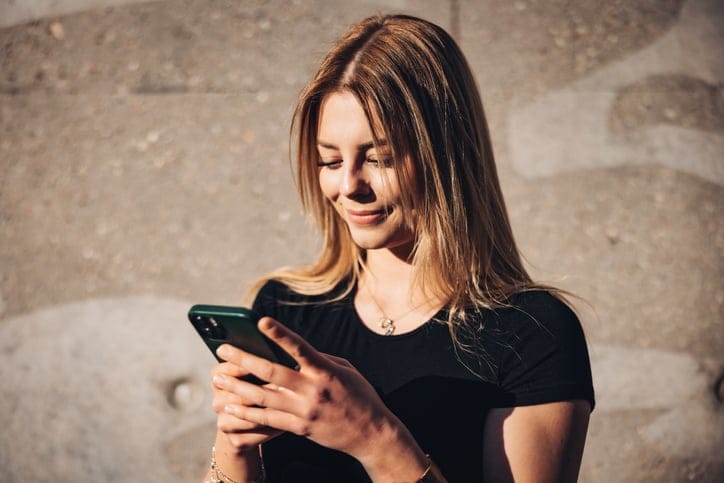 long haired attractrive woman using mobile