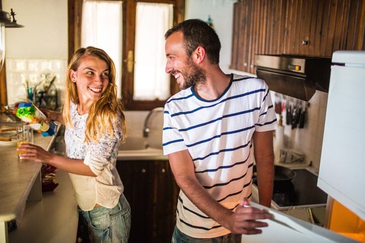 Couple making breakfast in the kitchen.