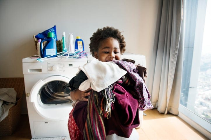 Young boy doing housework at home.