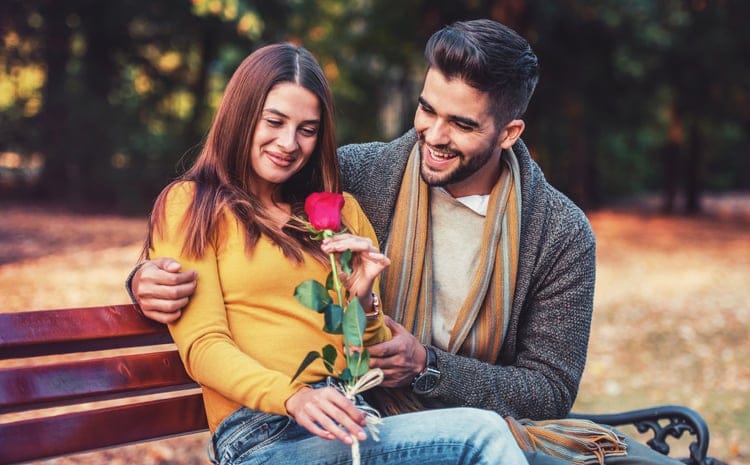 man giving a flower to a girl