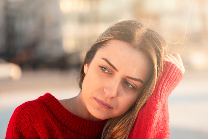 sad young woman in red