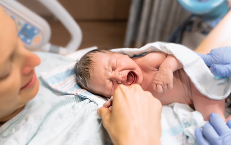 Mother holding her newborn baby.