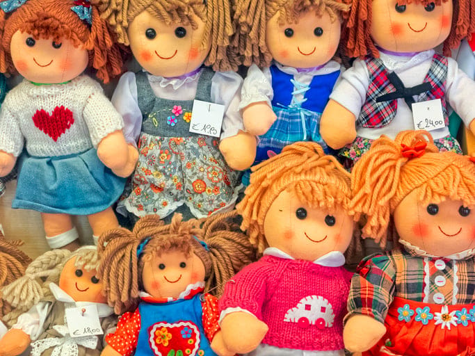 Rag dolls on display at a market.