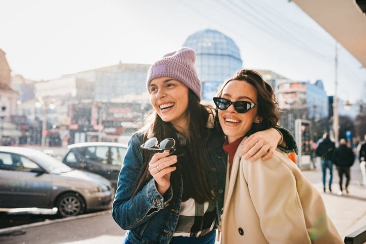 Female friends enjoying coffee outdoors.